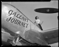 Woman standing atop a plane with the title, "Gallant Journey” painted on it, 1946