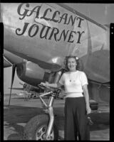 Woman standing beneath a plane with the title, "Gallant Journey” painted on it, 1946