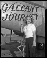 Woman standing beside a plane with the title, "Gallant Journey” painted on it, 1946