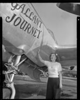 Woman standing beneath a plane with the title, "Gallant Journey” painted on it, 1946