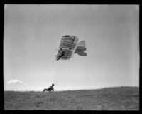 Man flying in a glider as another man watches from the ground (possibly during the filming of Gallant Journey), 1946