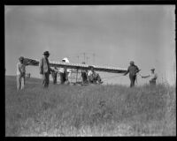 Men pulling a man in a glider (possibly during the filming of Gallant Journey), 1946