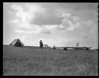 Men in a field with a glider and a tent (possibly during the filming of Gallant Journey), 1946