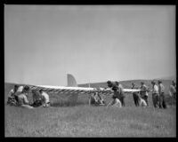 Crew working on and standing near a glider (possibly during the filming of Gallant Journey), 1946