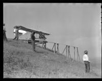 Man navigating a glider down a ramp as another men helps and other men stand nearby (possibly during the filming of Gallant Journey), 1946