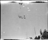 Daniel Maloney, aeronaut, flying a glider towed by a hot air balloon, circa 1905
