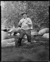 Jack Holt, actor, standing in a stream fishing, 1927-1939
