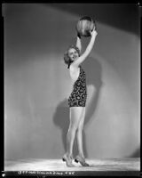 Virginia Dale, actress, in a swim suit holding a beach ball, circa 1938