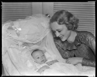 Sally Eilers, actress, beside her infant son, Harry Joe Brown, Jr., in his bassinet, 1934