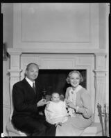 Sally Eilers, actress, with Harry Joe Brown, director, and their infant son, Harry Joe Brown, Jr., in front of a fireplace, 1934