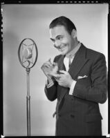 Edward Buzzell, director and actor, with a microphone, circa 1931-1935