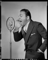 Edward Buzzell, director and actor, yelling into a microphone, circa 1931-1935