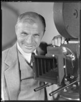 David Burton, director, with a film camera, circa 1933-1934