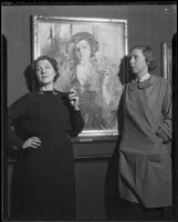 Nana Bryant, actress, and Anna Wilson, artist, posing next to Wilson's portrait of Bryant, Los Angeles, 1937
