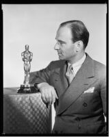 Robert Riskin, screenwriter, with his Academy Award for Best Writing (Adaptation) for It Happened One Night, 1935