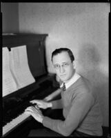 Louis Silvers, composer and Head of Columbia Pictures Music Department, sitting at a piano, circa 1933-1935