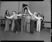 Robet Alton (possibly), choreographer, working with dancers during a rehearsal for You'll Never Get Rich, 1941