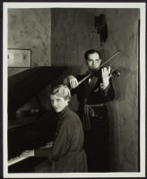 Joseph Schildkraut, actor, playing a violin while his wife, Marie, plays a piano, circa 1934