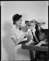 Florence Rice, actress, combing a dog, circa 1934-1936