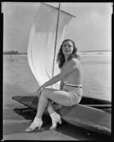 Geneva Mitchell, actress, sitting on a boat on a beach, 1934