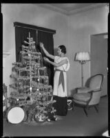 Geneva Mitchell, actress, decorating a Christmas tree, 1934