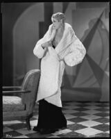 Peggy Hamilton modeling a white ermine coat, 1930