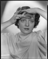 Sheila Mannors, actress, applying a cosmetic product to her forehead, 1934