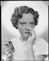 Sheila Mannors, actress, applying a cosmetic product to her nose, 1934