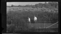 Two men in a field in an area near the flood following the failure of the Saint Francis Dam, Santa Clara River Valley (Calif.), 1928