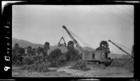 Cranes engaged in clean-up of debris left by the flood that followed the ruin of the Saint Francis Dam, Bardsdale, 1928