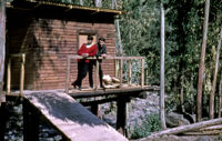 Chile - Two men on deck of wooden cabin on stilts, between 1966-1967