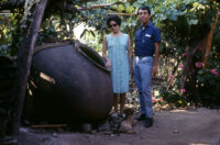 Chile - Woman, young man, and dog standing next to large pot, between 1966-1967