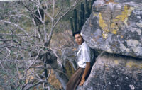 Mexico (Jalisco) - Young man leaning against rock formation with cacti, between 1960-1964