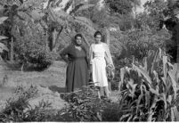 Khurshid Khanum Janmohamed Cassamali Jairazbhoy and Mrs. Patricia O’Shea Jairazbhoy standing in Khurshid Jairazbhoy’s garden, Malir Village (Pakistan), 1963