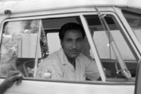Man seated inside the VW van of Nazir Jairazbhoy, Mumbai (India), 1963-1964