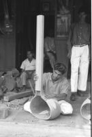 Instrument maker attaching the stem of a sitar or taṃbūrā at Vilayat Hussain brothers, Miraj (India), 1963