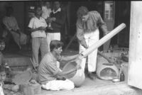 Instrument maker attaching the stem of a tanpura at Vilayat Khan brothers, Miraj (India), 1963