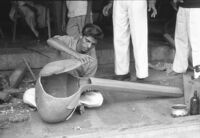 Instrument maker fitting the face of a sitar or taṃbūrā at Vilayat Hussain brothers, Miraj (India), 1963