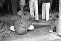 Instrument maker fitting the face of a tanpura at Vilayat Khan brothers, Miraj (India), 1963