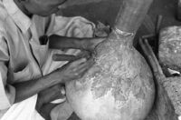 Instrument makers sculpting leaves on a gourd at the shop of Abdul Karim Ismail, instrument maker, Miraj (India), 1963