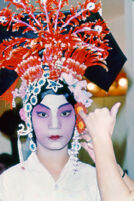 Putting on headdress of Manchurian princess for the first act of Szu Lang T'an Mou