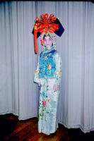 Putting on headdress of Manchurian princess for the first act of Szu Lang T'an Mou